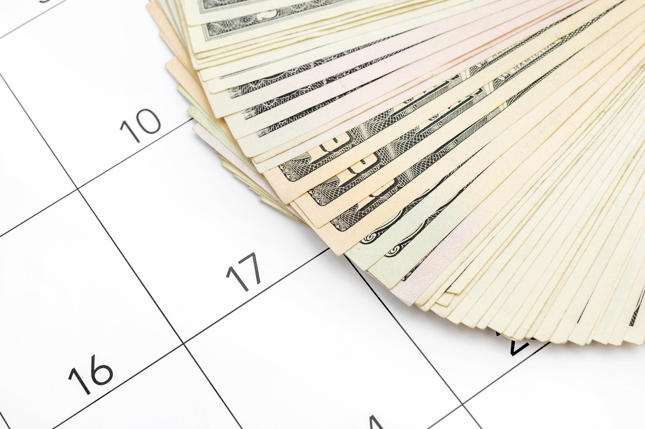 A pile of money on a calendar.