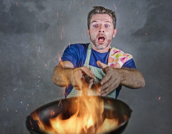 Man with frying pan on fire
