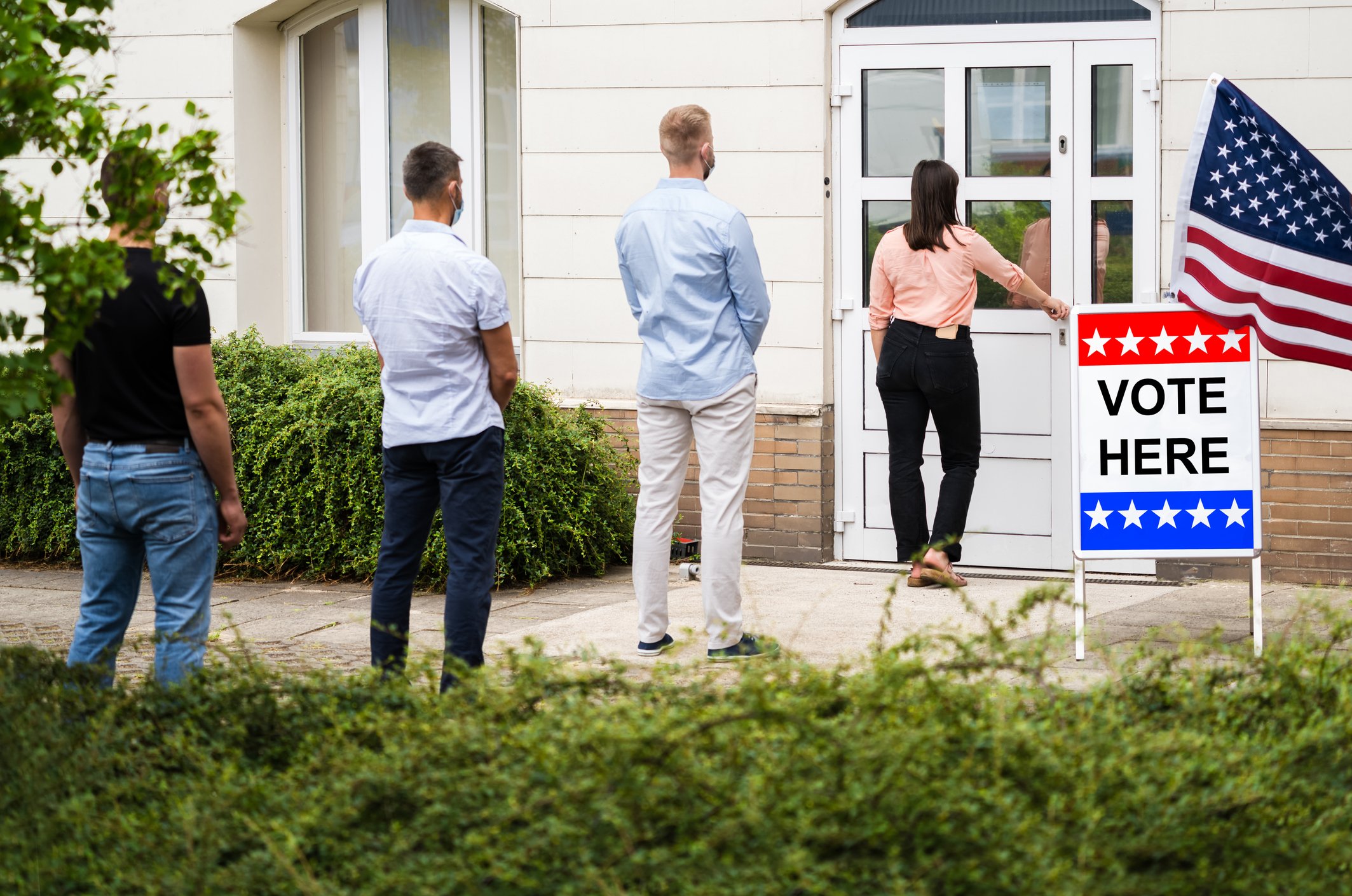 People standing in line to vote. 