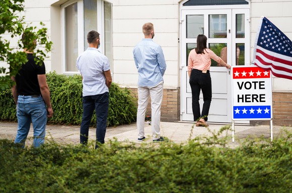 People standing in line to vote. 