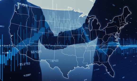 Two politicians shaking hands superimposed on a U.S. map and stock chart.