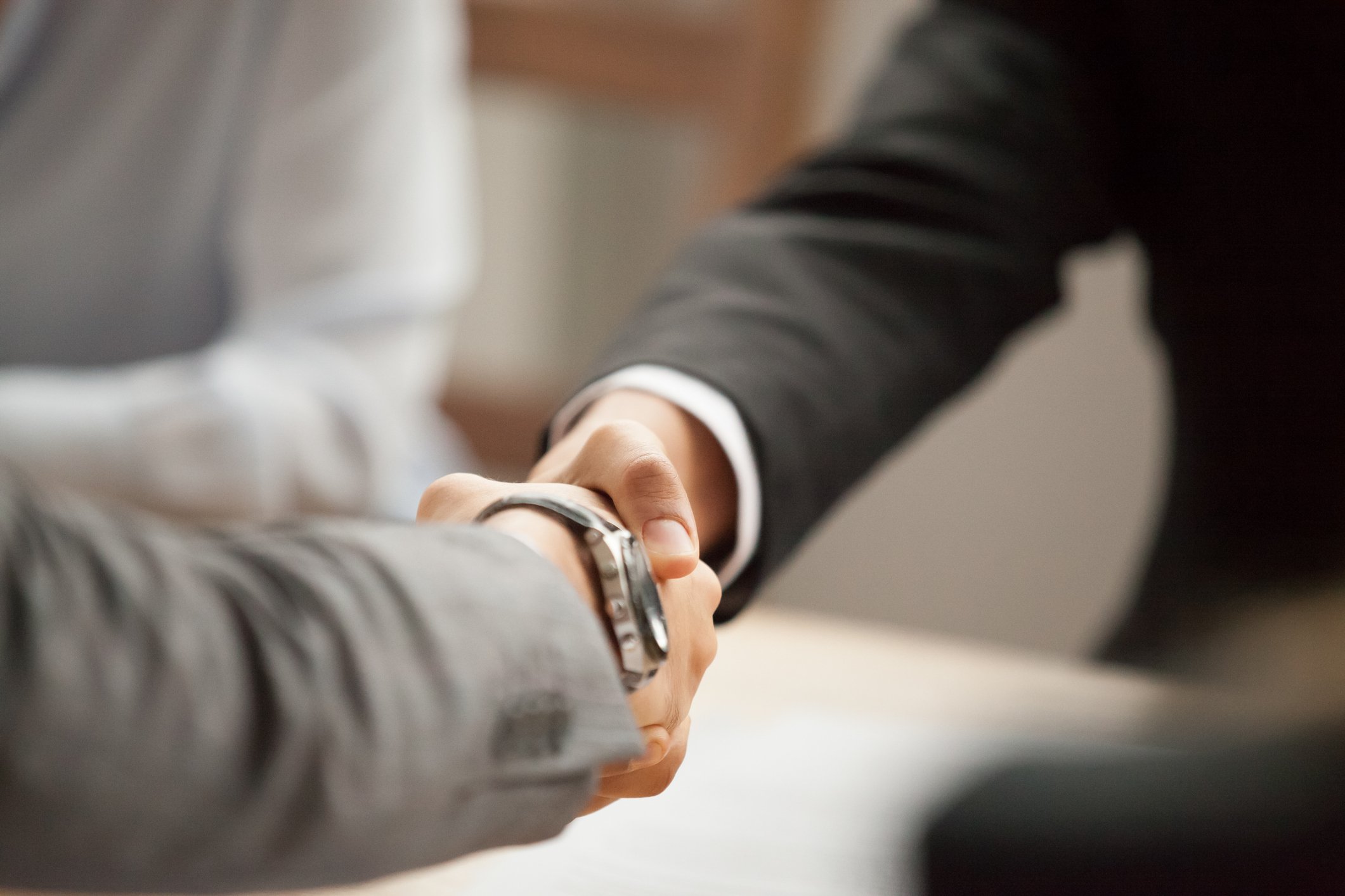 shaking-hands-in-suits-getty