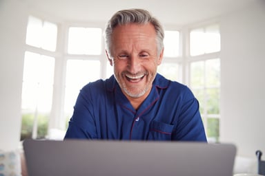 Smiling man at laptop_GettyImages-1186911980