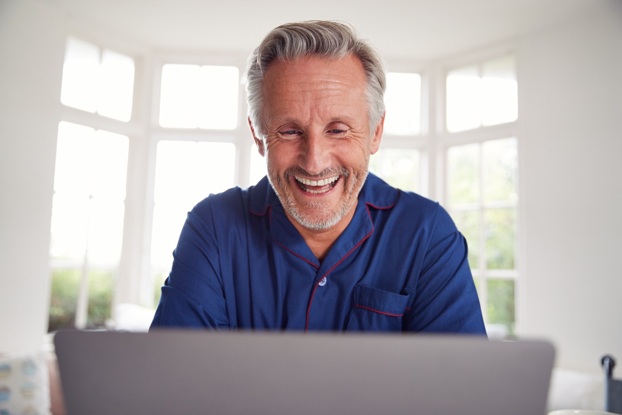 Smiling man at laptop