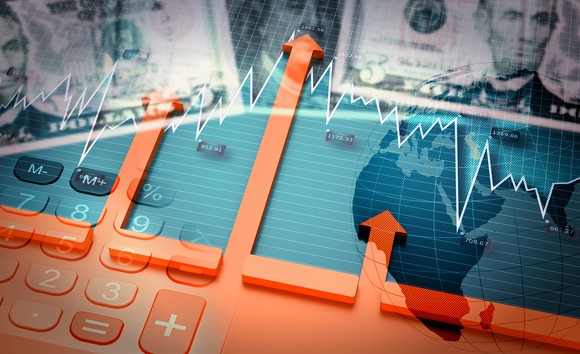 Money and arrows going up over a calculator.