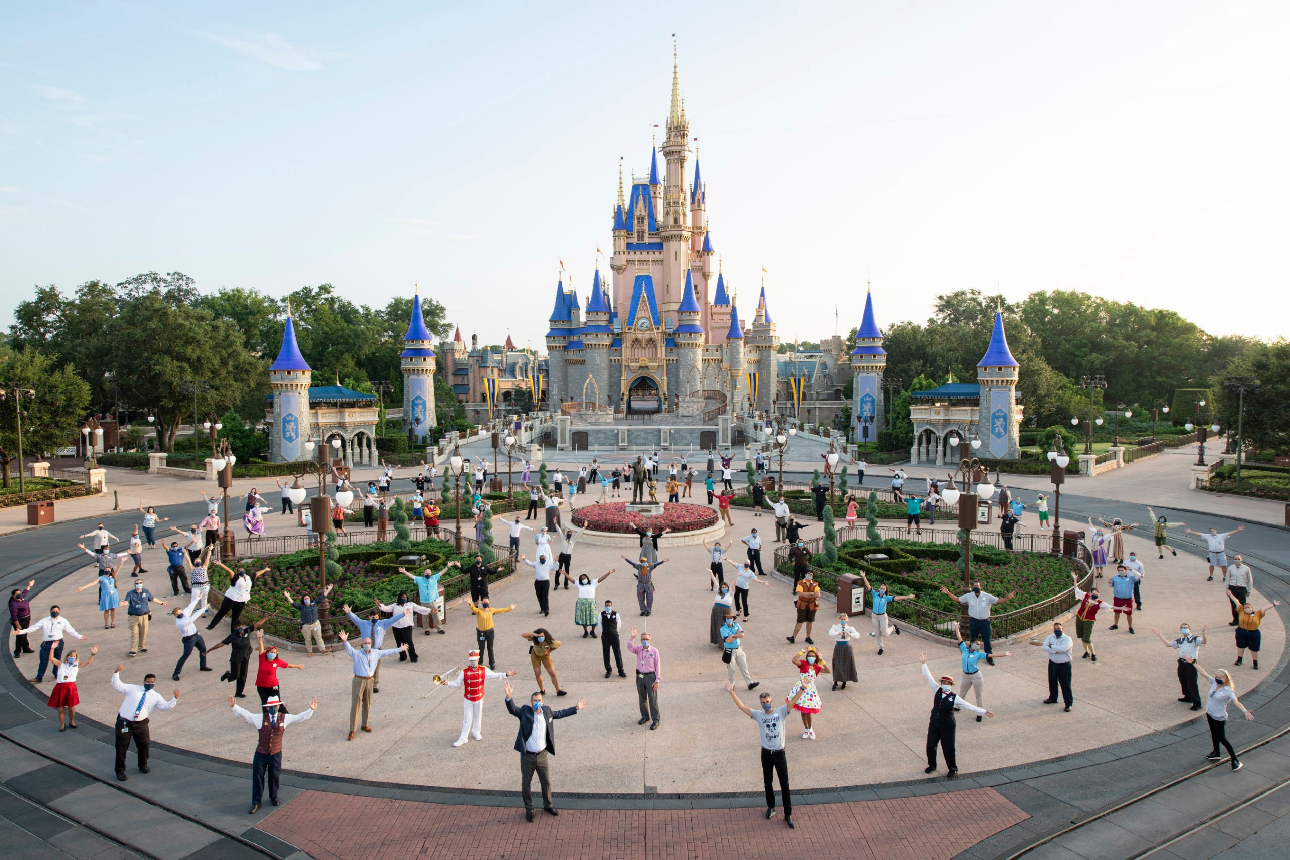Walt Disney World reopening with cast members in front of the Disney castle