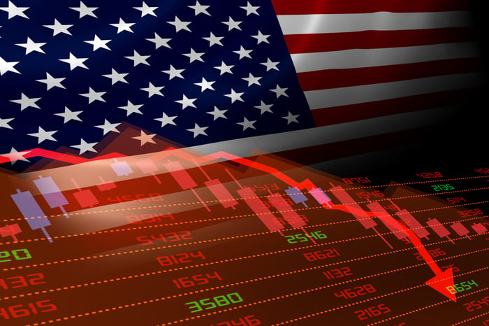 Stock charts going down with U.S. flag in background