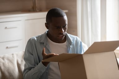 confused customer opening box
