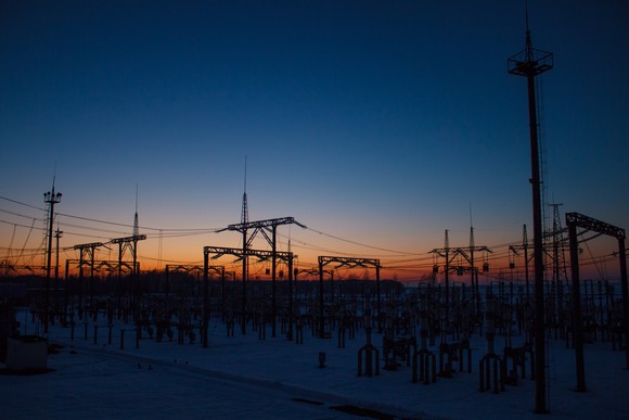 An electrical substation at dawn or dusk.