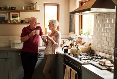 senior couple drinking coffee in the kitchen