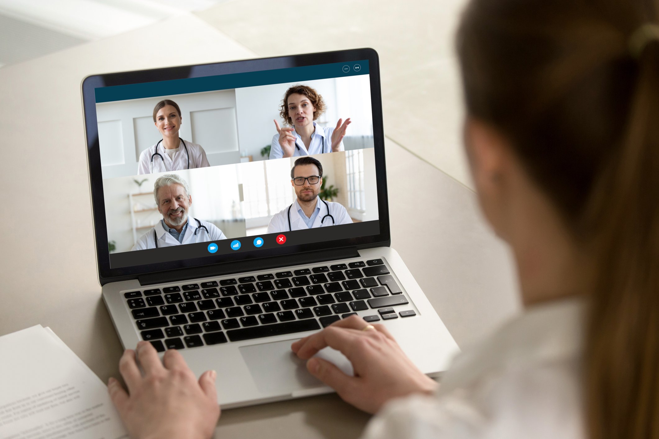 Person on a Zoom meeting with four doctors in separate boxes.
