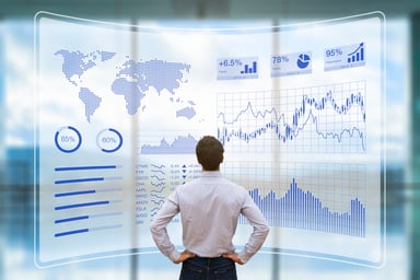 Investors looking at a big board of charts