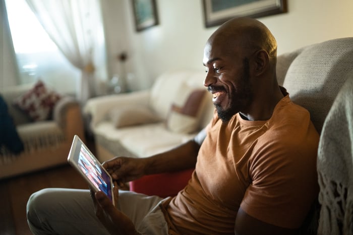 Man using tablet to make a video call.