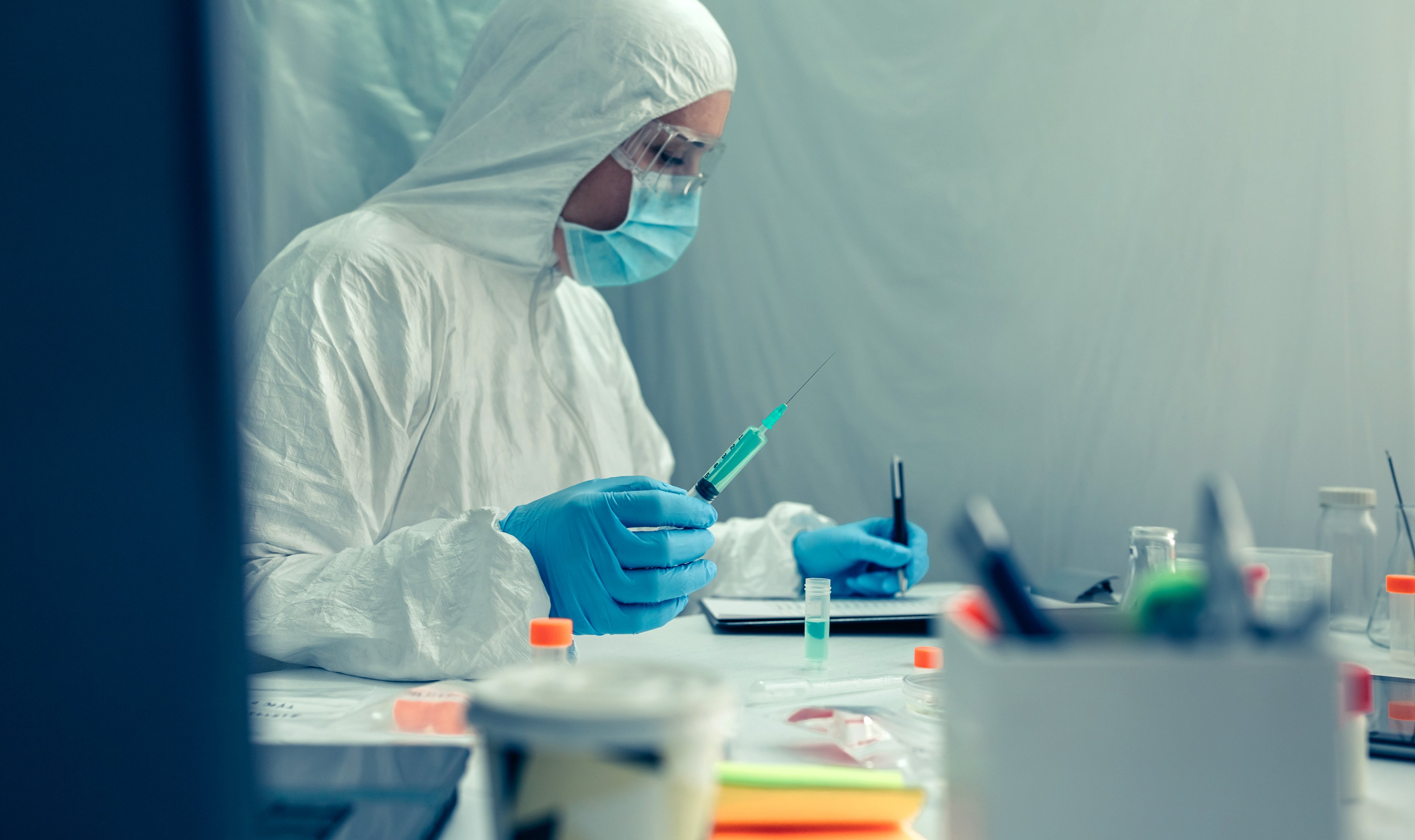 Scientist investigating vaccine in a makeshift laboratory.