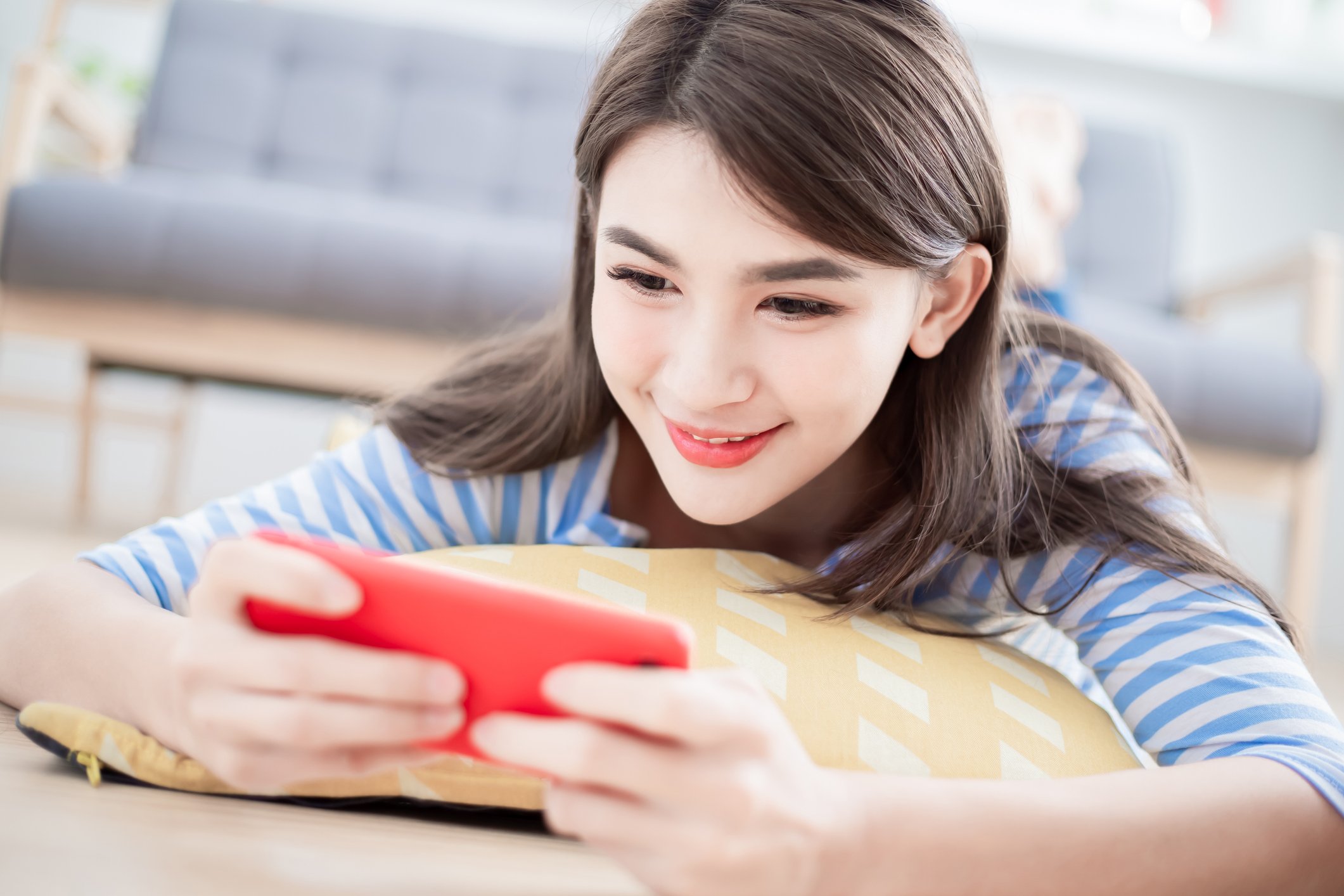 Young girl playing a game on her smartphone