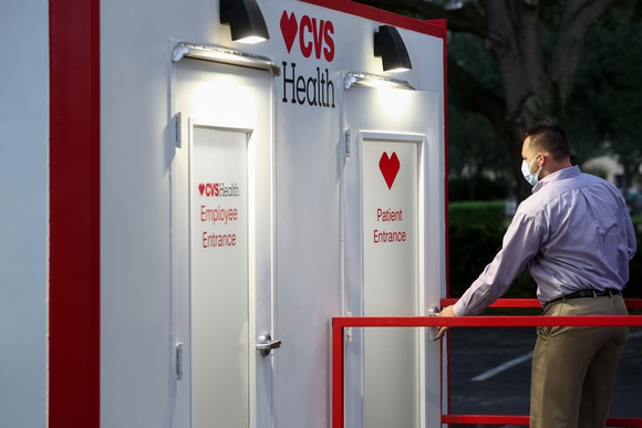 CVS Health rapid testing area with a man wearing a mask standing outside