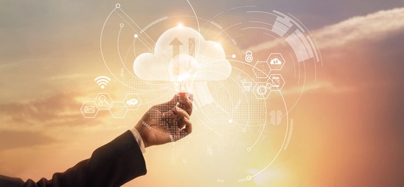 A hand touching a cloud upload-download icon.