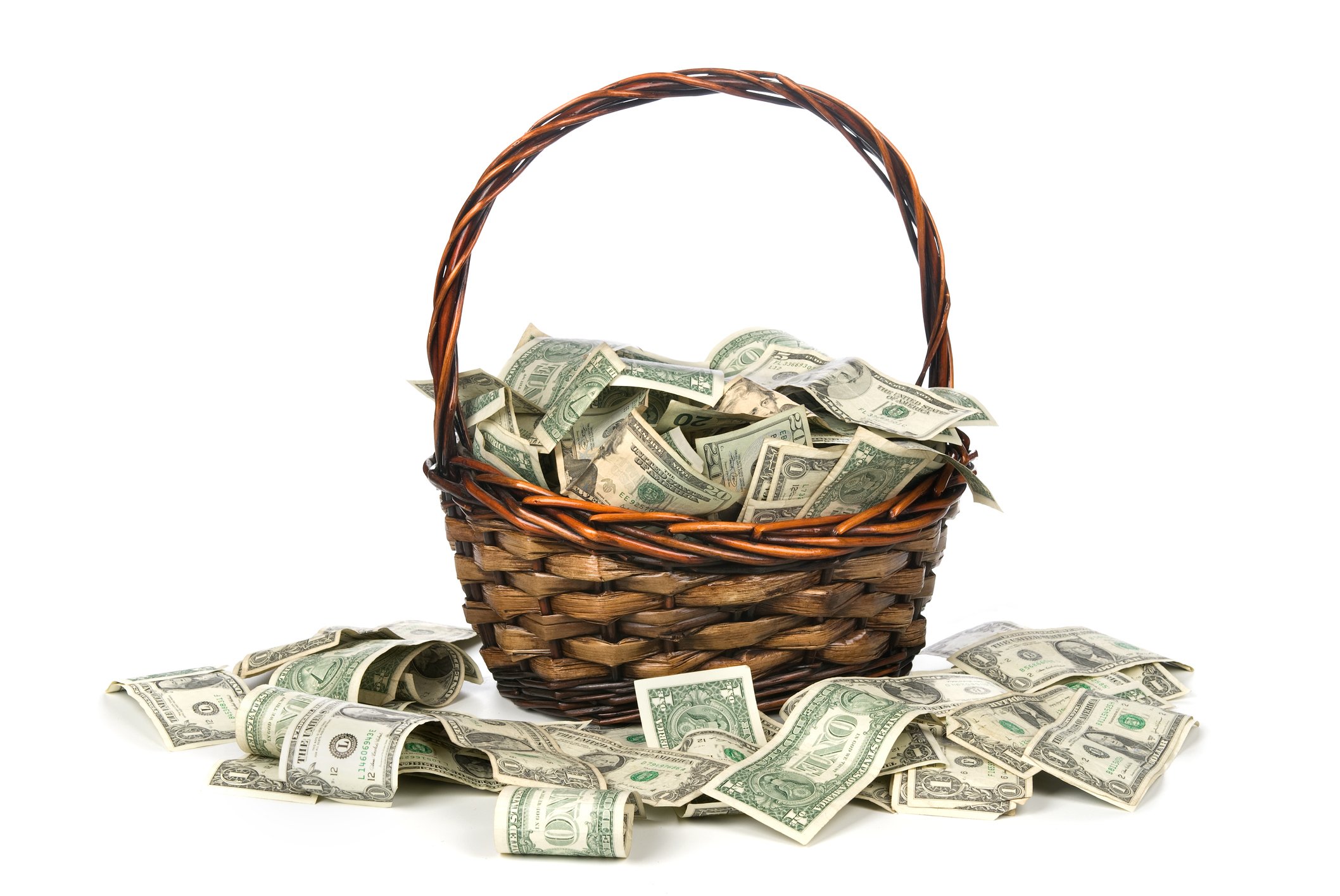 Basket full of cash with cash surrounding it.  