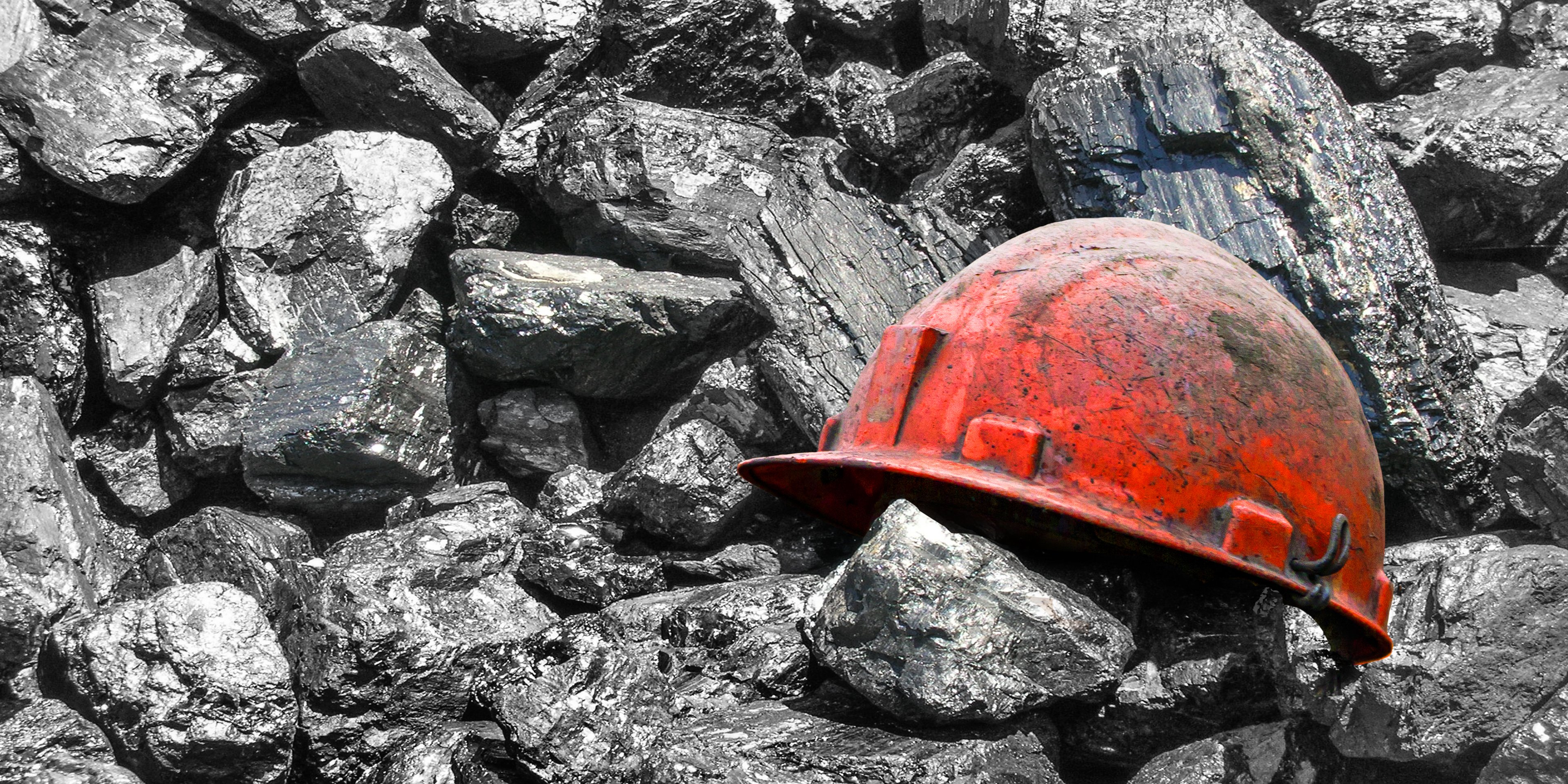 A hard hat among lumps of coal.
