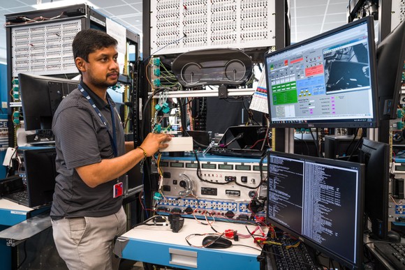 GM technician working on computer equipment