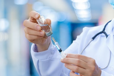 doctor holding syringe