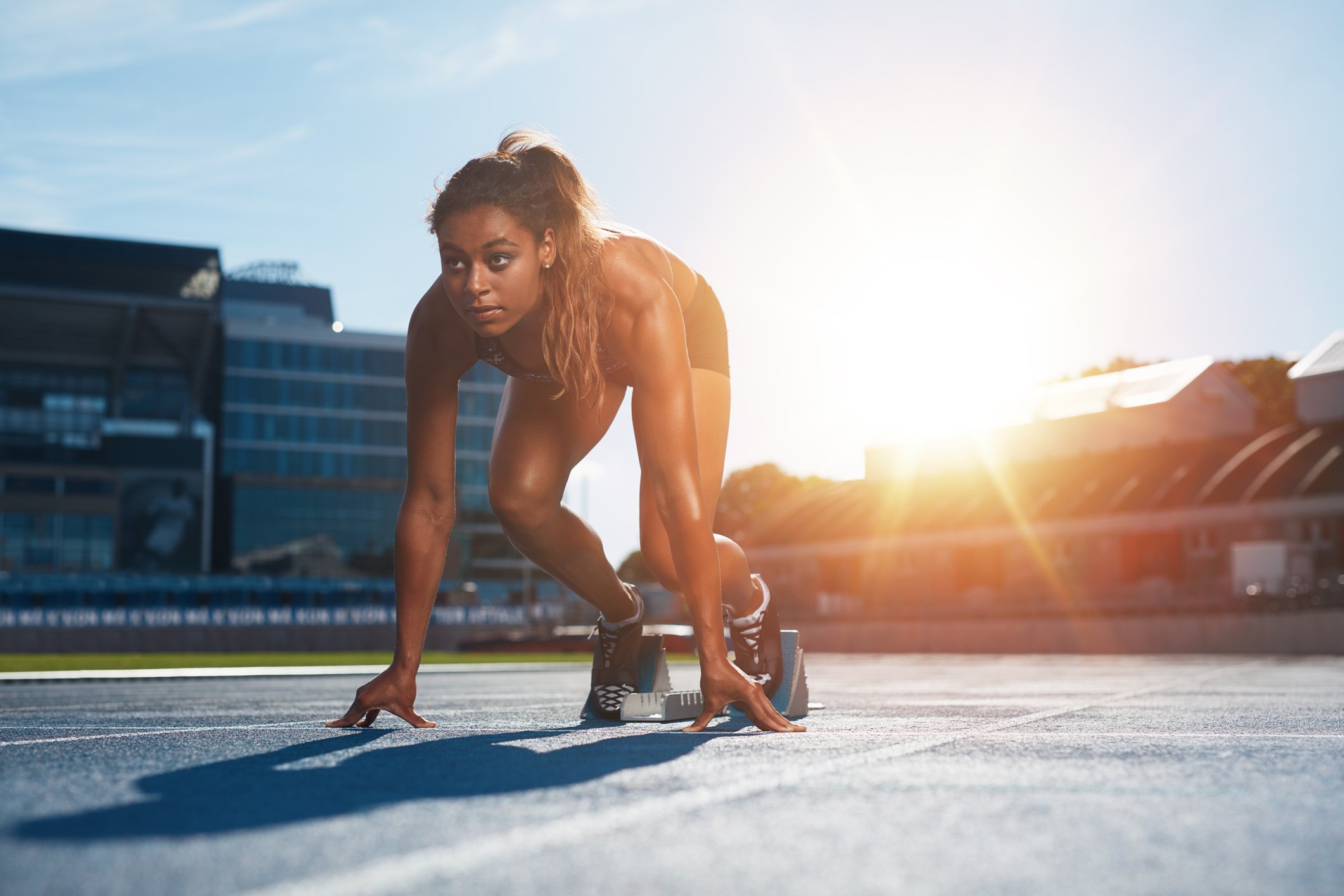 A professional runner gets ready to sprint.