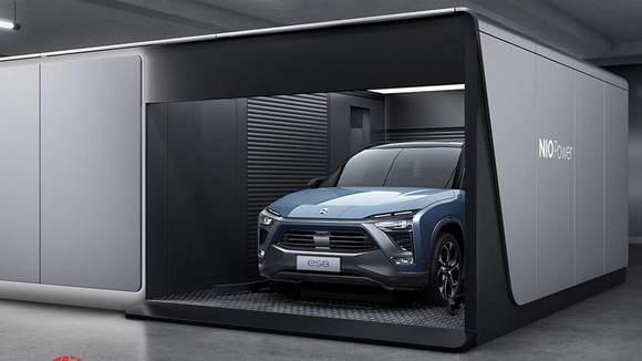 A NIO ES8, an upscale electric SUV, inside an automated battery-swap station.