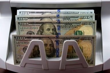 $100 bills in a counting machine