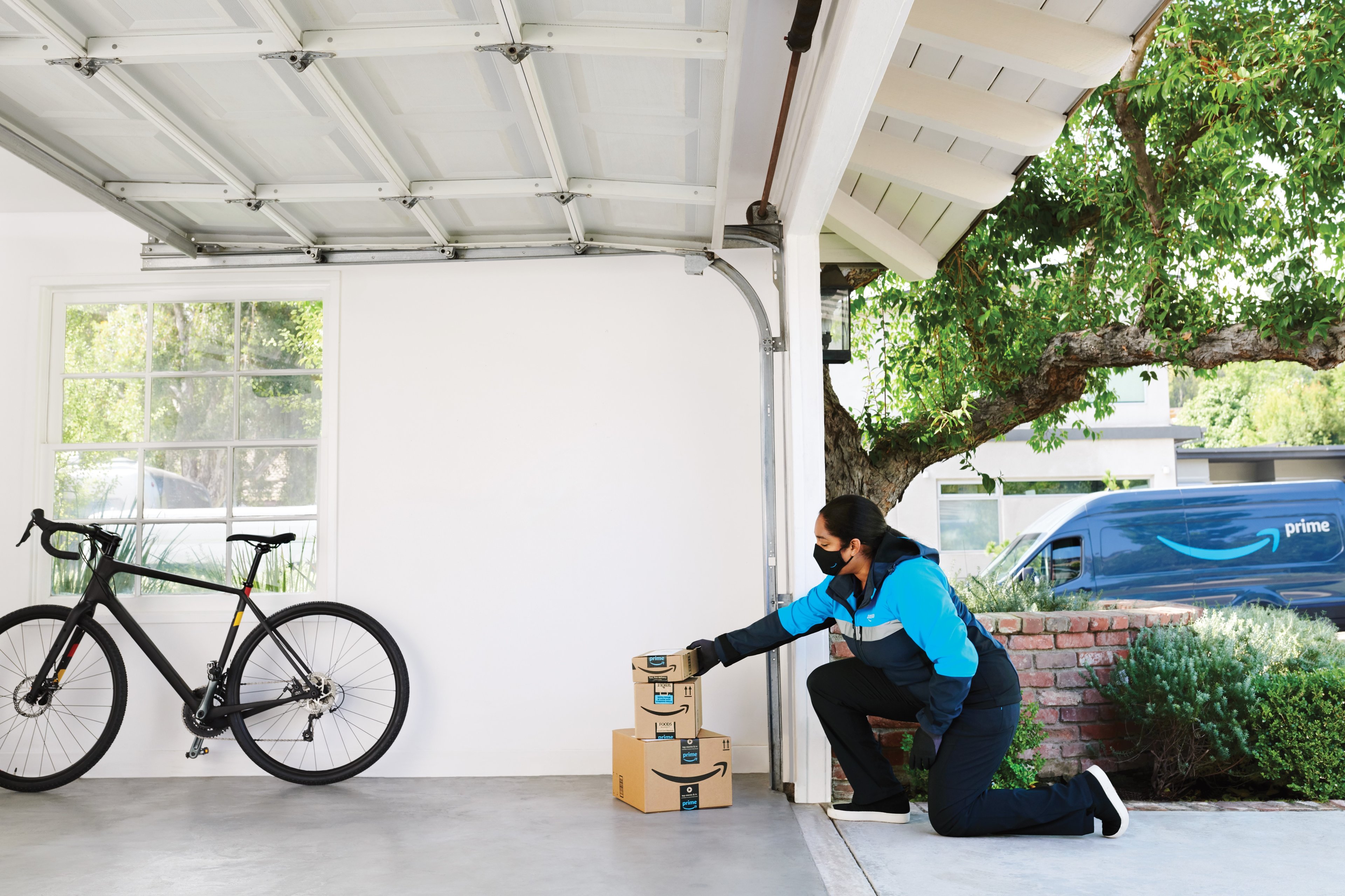 Woman placing Amazon.com boxes inside garage