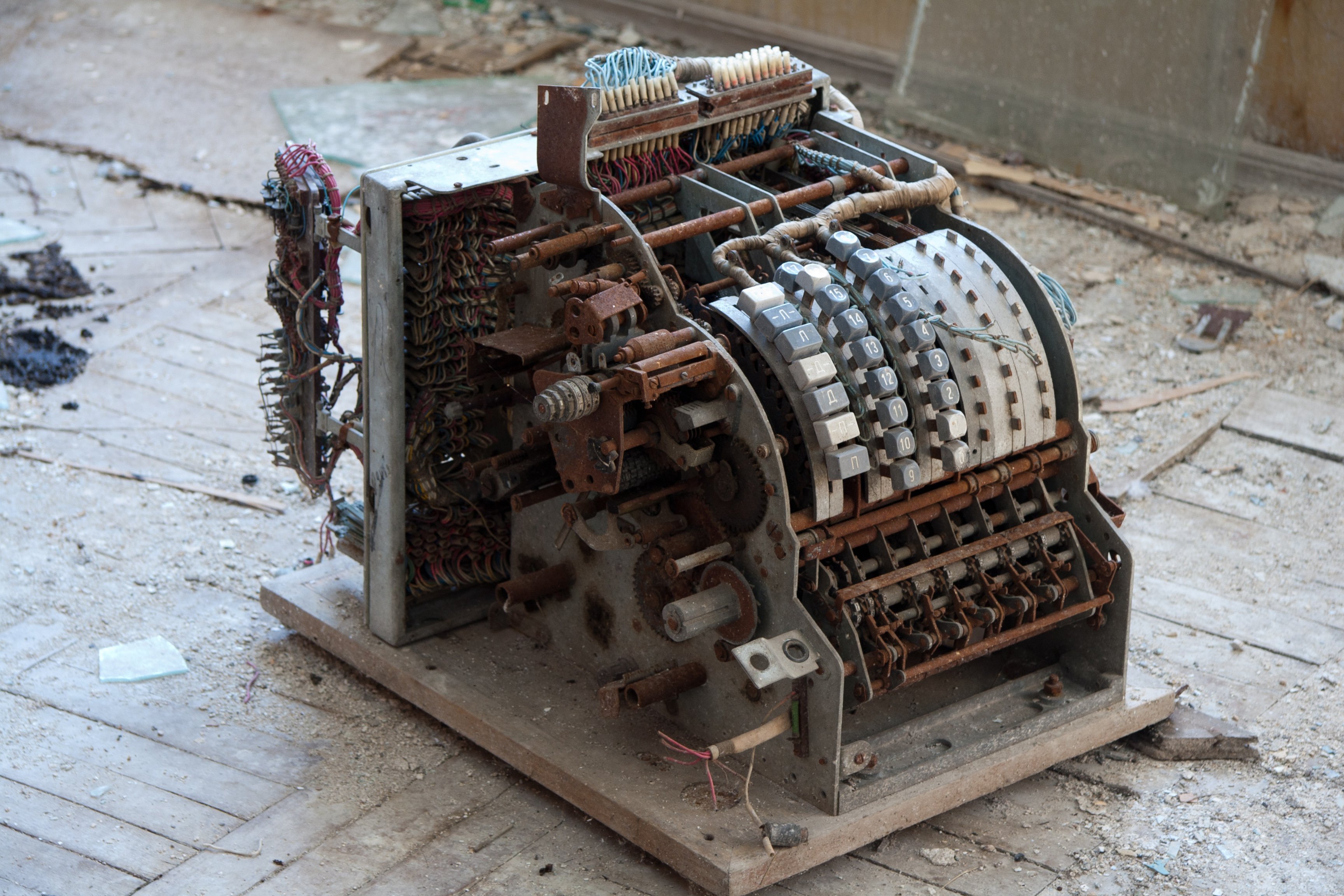 A broken, rusty cash register