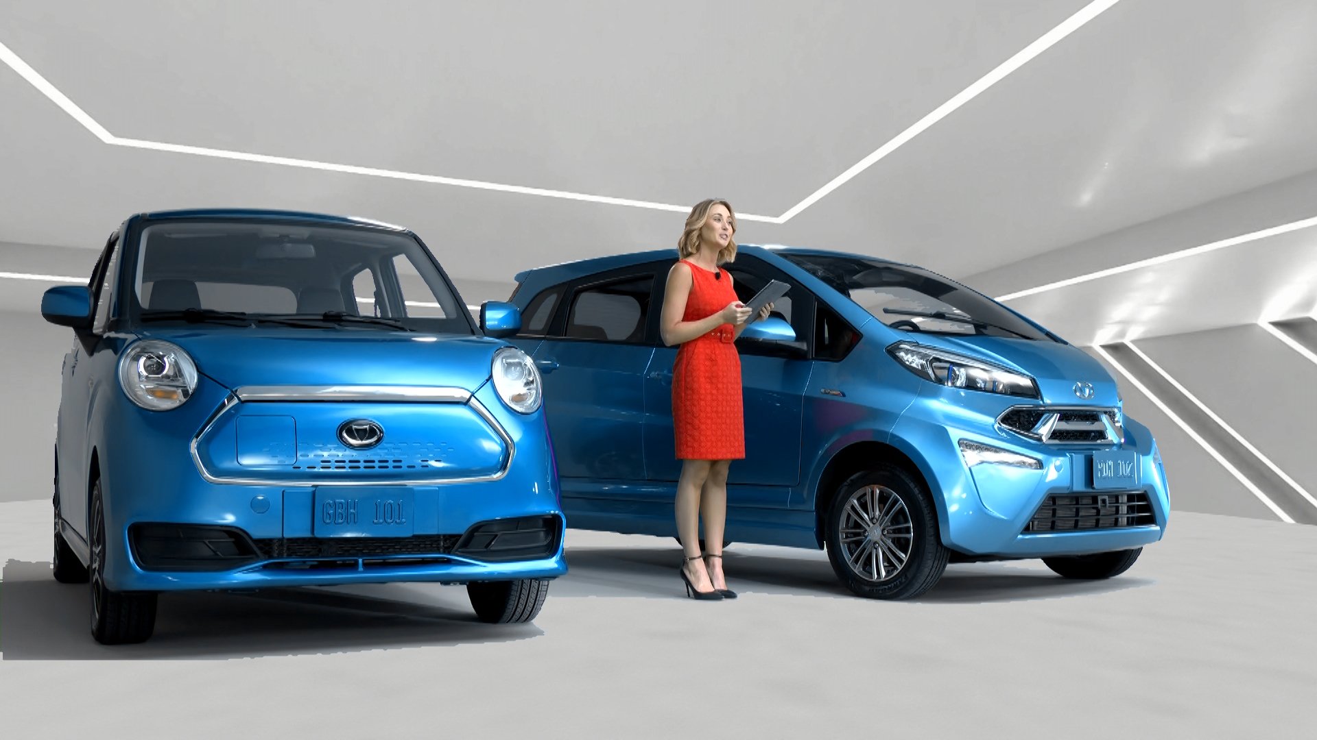 Two Kandi cars with a woman standing between them