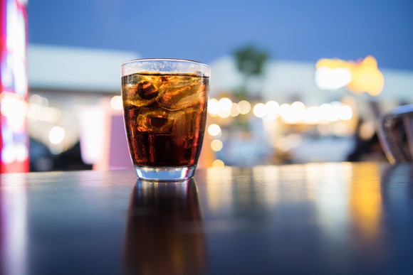 A glass of coke in a bar.