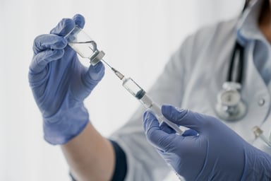 Physician holding a vaccine shot