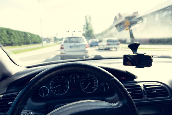 A highway as seen from the driver's seat in a car.