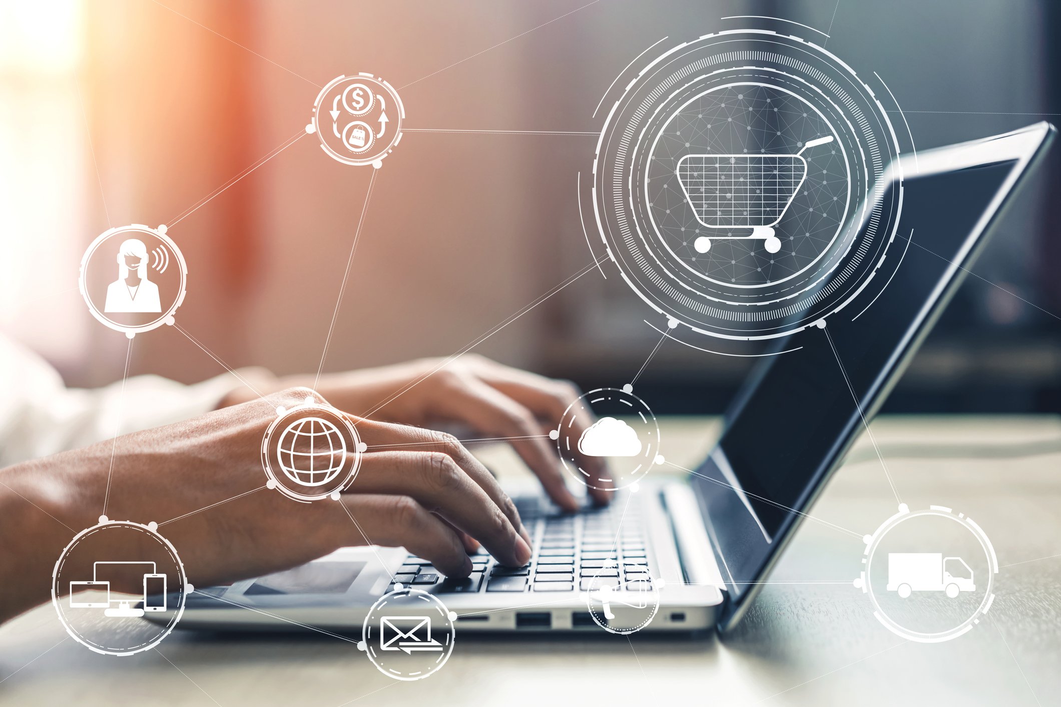 Hands typing on a laptop with e-commerce icons overlaid