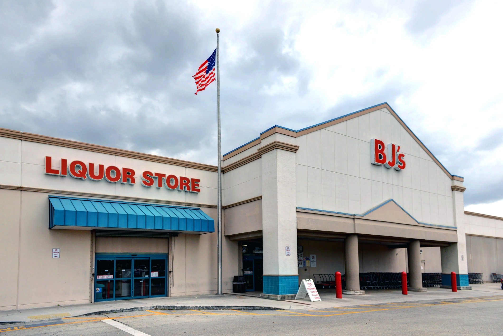 The outside of a BJ's Wholesale store and a liquor store.