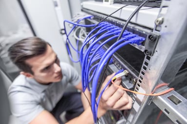 Man working in network server room