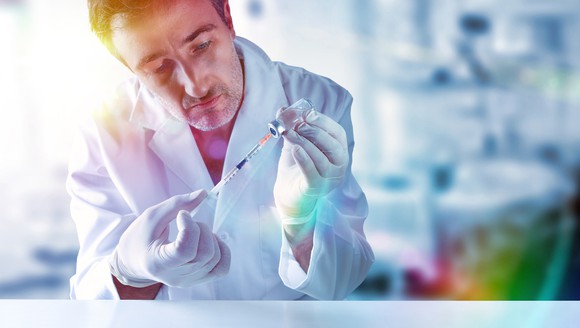 Person preparing a vaccine.