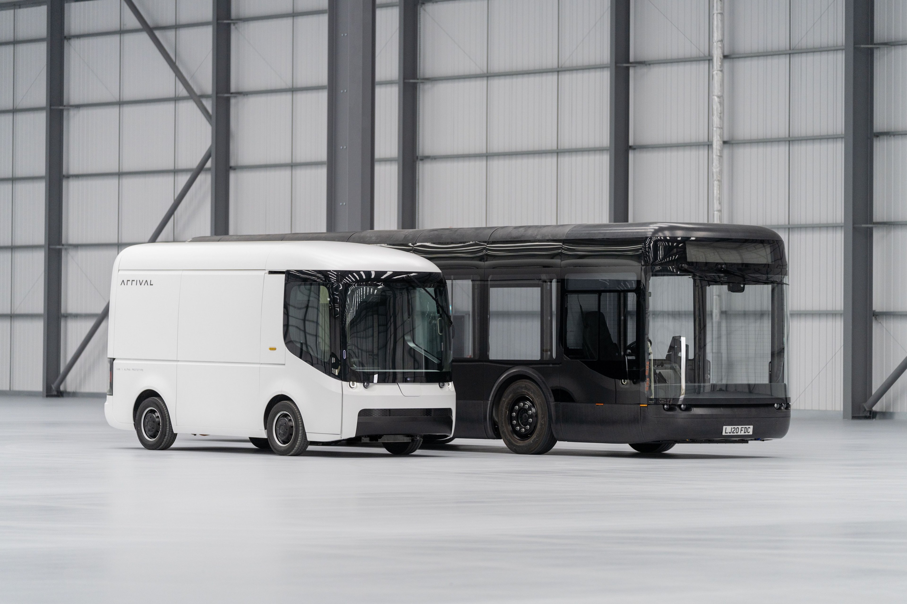 Arrival van and bus on display in warehouse