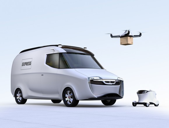 electric delivery truck with drone overhead holding package