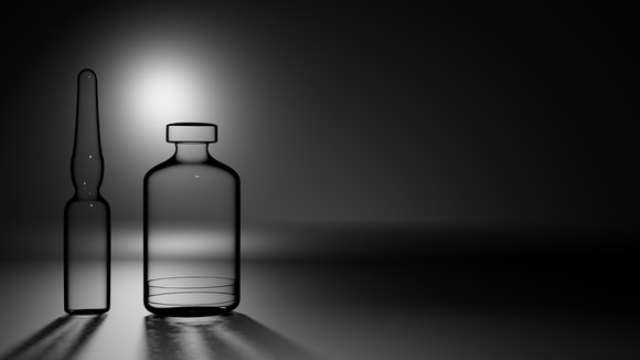 Glass vial and ampule with a gray background 