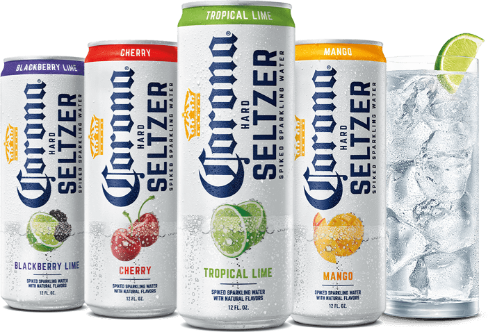 Four cans of Corona Hard Seltzer next to a glass filled with ice and seltzer 