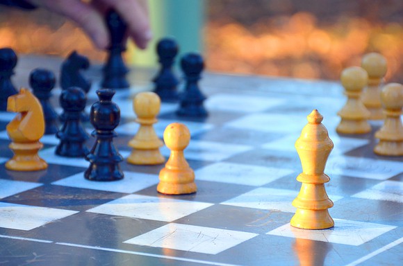 A player contemplates a move in a chess game.