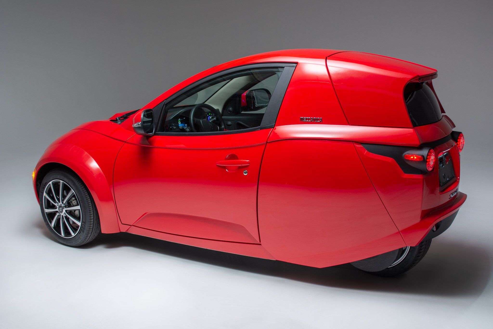 A red ElectraMeccanica Solo, a tiny 3-wheel electric car. 