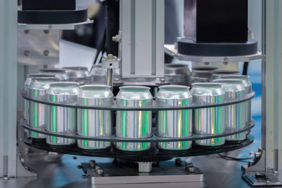 Aluminum cans on a conveyer at a beverage canning facility.