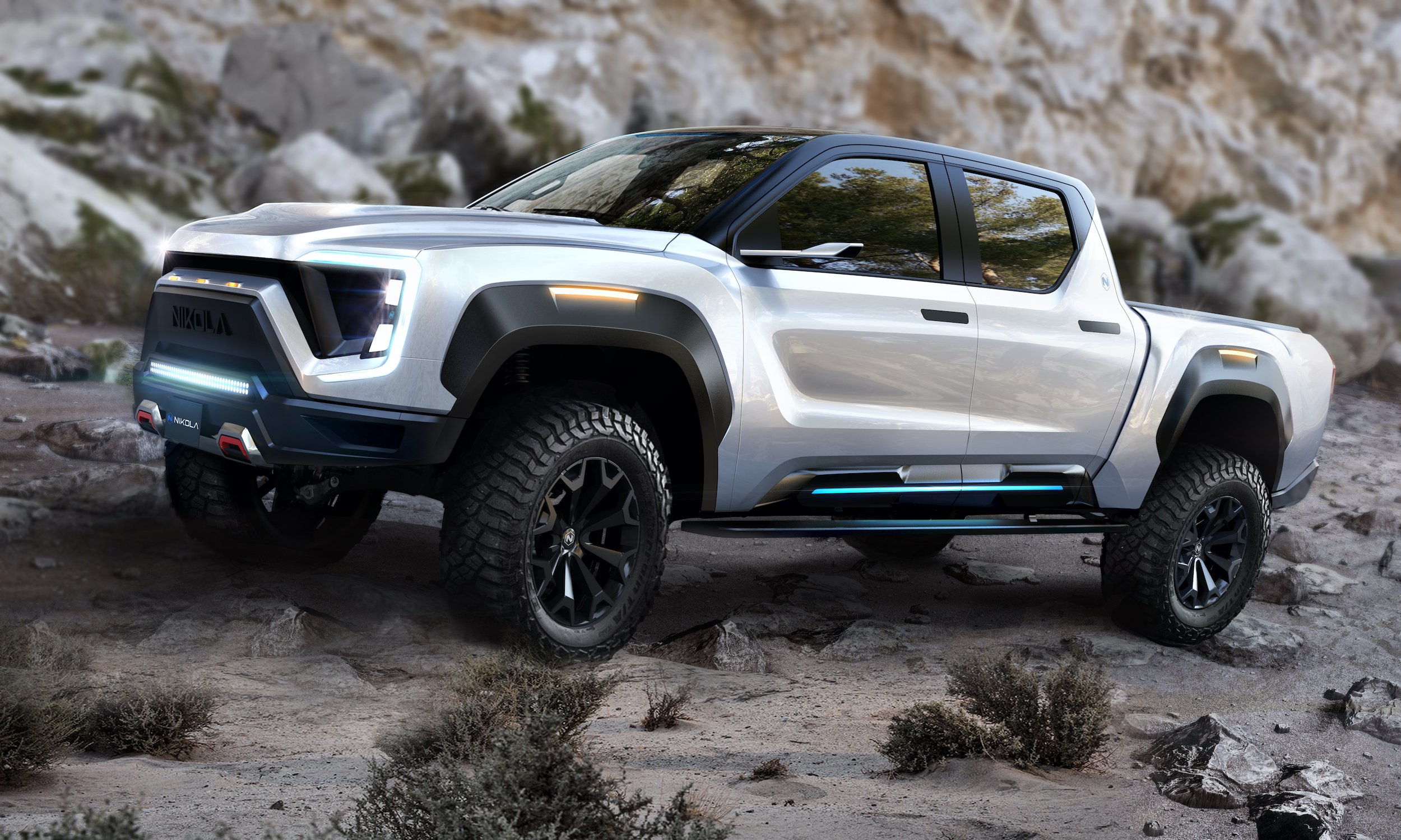A prototype Nikola Badger electric pickup truck, on a rocky surface.