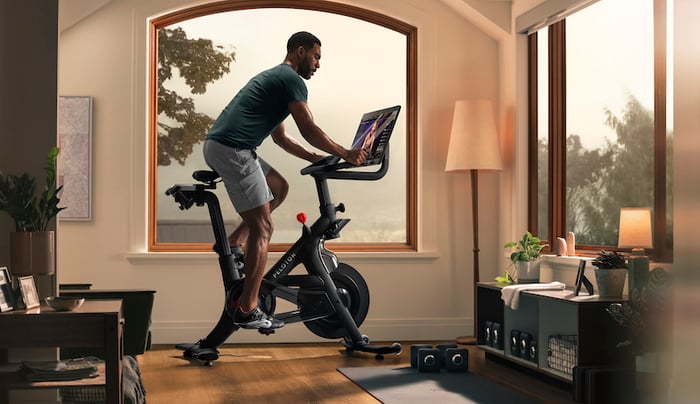 A man rides Peloton's Bike+ exercise bike.