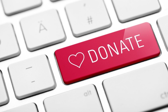 A red key on a keyboard labeled DONATE with a heart beside it.