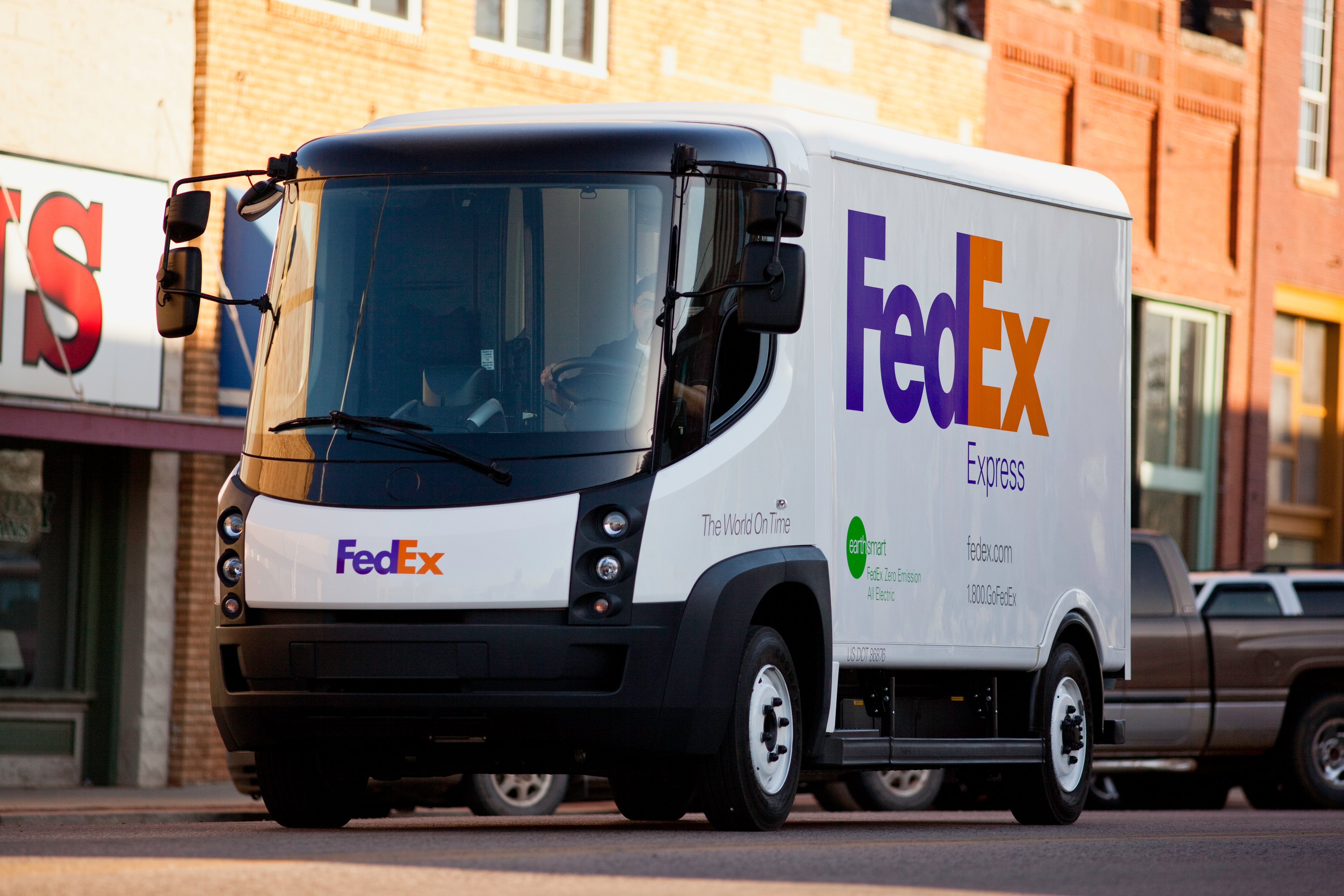 A FedEx delivery truck in a city setting.