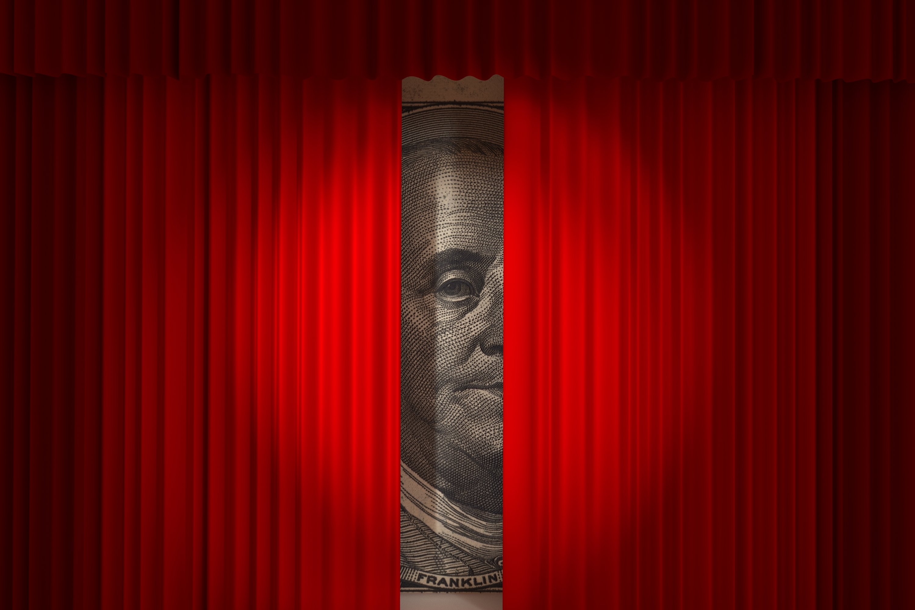 Huge picture of Ben Franklin from $100 bill behind a red curtain